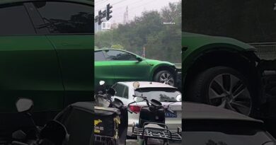 Chinese driver survives after her Tesla is sent flying, landing on parked cars #shorts